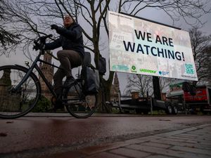 Activists put up a billboard outside the International Court of Justice, in The Hague, Netherlands