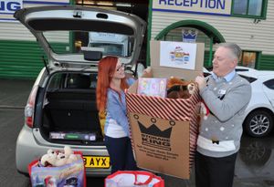 Tim Drew of Storage King gives a helping hand to Rachel Lewis of Hope House