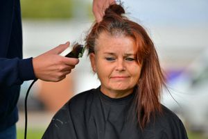 The work begins to shave off Donna's hair