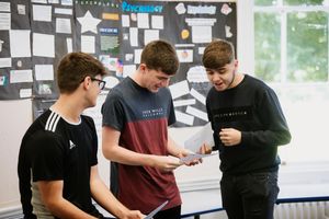 Tom Heather, in the middle, opens his results at Grove School and Sixth Form in Market Drayton