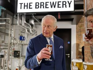 Supporting image for story: Charles plays barman and pulls the ‘perfect’ pint of Guinness