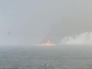 Black smoke billowing into the air after a crash between an oil tanker and a cargo ship off the coast of East Yorkshire