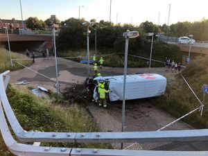 The van had gone through the railings on Albion Roundabout and landed on its side. Photo: West Bromwich Fire