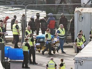 Stretcher of equipment is wheeled through the Border Force compound as a group of people thought to be migrants are brought in to Dover, Kent, from a Border Force vessel