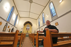 Father Craig Fullard from the Newman cluster of churches with the restored ceiling