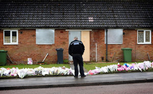 A police officer stands over the tributes in Valley View, Brownhills