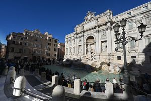 A general view shows tourists visiting the Trevi Fountain in Rome. (Photo by Andreas SOLARO / AFP via Getty Images)
