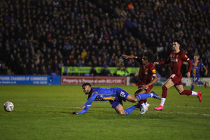 Josh Laurent of Shrewsbury Town wins a penalty under a tackle from Yasser Larouci of Liverpool (AMA)