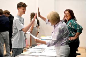 Ercall Wood Academy pupil Luke Austin gets a high five at the results desk from Kim Drake as Christine Holmes watches on