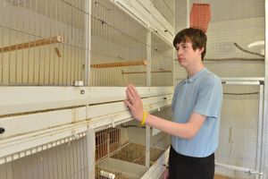 Aaron Burgess,15, by the empty cages in the aviary