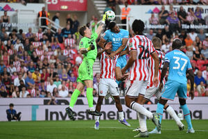 Walsall defender Priestley Farquharson challenging in the air. (Image by Owen Russell)