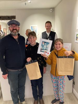 First customers James, Oscar and Phoebe Alexander, who camped out overnight  