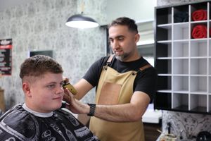 Owen Norgrove with Barber Firat Davutoglu atTurkish Barber in Ludlow, Shropshire. Barber Firat saved customer's Owen's life after finding lump on his neck that turned out to be Hodgkin Lymphoma cancer. Owen is in remission now