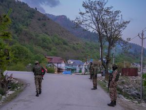 Indian security personnel stand guard