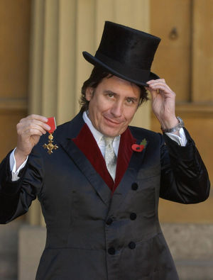 Musician Jools Holland at London's Buckingham Palace in 2003, after being awarded with an an OBE by Britain's Queen Elizabeth II