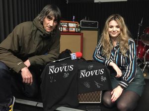 Mark Piddington and fellow team-member Danielle Clarke pose with some signed The Novus t-shirts