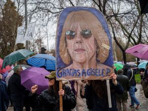 Gisele Pelicot's face on a banner on International Women's Day