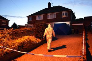A forensic officer outside the Halesowen home last night.