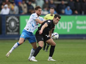 John Marquis controls the ball under pressure from Barrow's Charlie Raglan