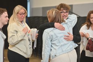 Burton Burough School pupil Alex Cutler, gets a hug from Karen Steadman, watched on by teacher and mentor Rachel Paginton