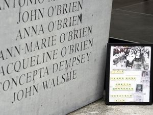 A framed picture sits beside the memorial to the victims of the Dublin and Monaghan bombings