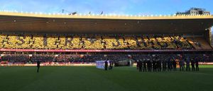 Fans in the upper tier of the Steve Bull stand hold up their cards to spell out the name Sir Jack during Saturday's tributes to the former Wolves owner
