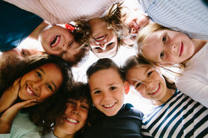 Children smiling in a friendship circle