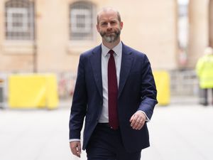 Jonathan Reynolds smiling as he walks along a street