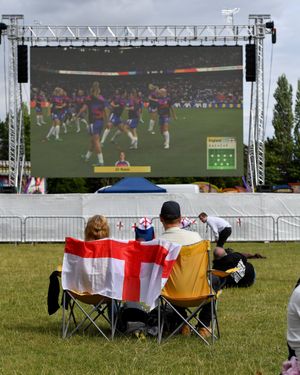 Football fans watch the match on the big screen. Photo: Tim Thursfield