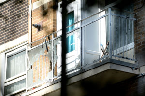 The smashed third-floor balcony where the man was stood
