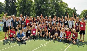 Biathlon competitors celebrate finishing the event