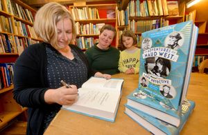 Susannah Stapleton signing a book for Eve Mallen, 6, and Francesca Mallen