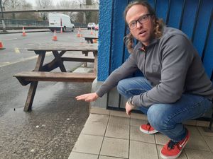 Ollie Parry showing where the flood water could rise to at The Salopian in Smithfield Road