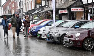 Visitors to the Bridgnorth Italian Moto Fest brave the horrendous downpours to view the cars on show