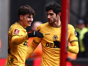 Wolverhampton Wanderers' Portugese midfielder #19 Rodrigo Gomes (L) celebrates with Wolverhampton Wanderers' Portuguese striker #29 Goncalo Guedes (R)(Getty)