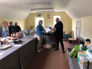 Anne-Marie Jackson presents a prize of six free tennis lessons and three months membership from Bishop's Castle Tennis Club to lucky winner Chris