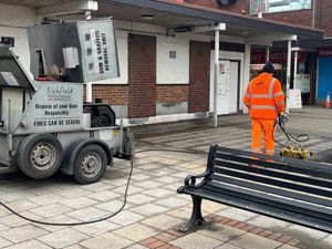 A member of Lichfield District Council’s Streetscene team jet-washes the floor surface at Burntwood Shopping Centre.