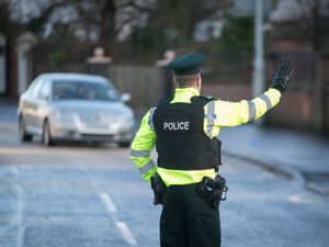 A police officer flagging down a vehicle