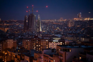 Buildings and La Sagrada Familia basilica illuminated at night in Barcelona lifting spirits during the outbreak