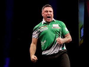 Gerwyn Price celebrates on stage