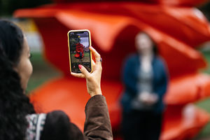 People taking pictures with Red Stack on University of Birmingham campus.