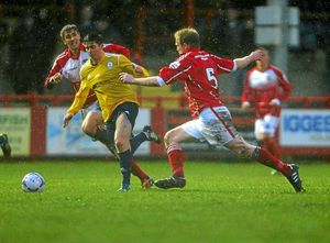 Charlie Barnett of AFC Telford United and Dan Wordsworth of Workington