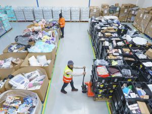 (l to r) Mohammed Konateh and Sabbir Ahmed Sumon pack goods at the new West Midlands Multibank in Birmingham