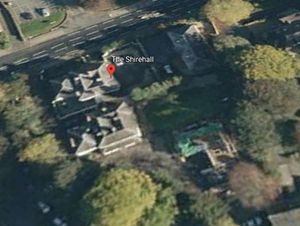 The planning application is to create additional parking on tennis courts at the rear of the building. Photo: Google Earth.