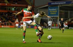 Walsall's Conor Wilkinson battles with Oldham's Sam Hart.