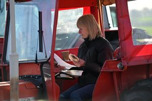 A tractor driver grabs a bite to eat and inspects the route