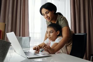 Foster parent looking after foster child while working