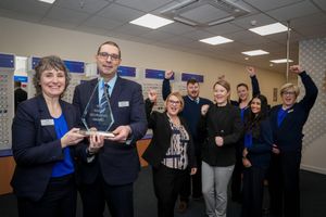 L-R -  Yvette Sidhu and Paul Sidhu with the team and their award in the Halesowen Scrivens branch