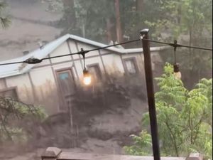 Supporting image for story: Three missing and house swept away as flash flooding hits mountain village in US