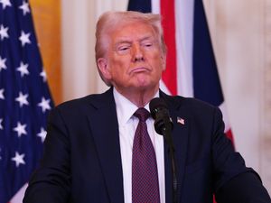 Donald Trump in front of US and British flags